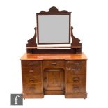 A Victorian mahogany duchess dressing table fitted with nine drawers around the central cupboard,