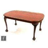 An Edwardian mahogany centre table of rounded rectangular form, on cabriole legs with claw and