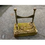 A George III cast iron boot scraper mounted on a stepped concrete base, height 41cm.