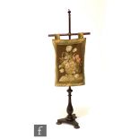 A 19th Century mahogany pole screen with later floral tapestry panel, height 142cm.