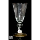 An early 18th Century oversized goblet circa 1710, the round funnel bowl above a large spherical