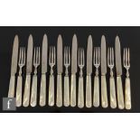 A set of silver hallmarked fruit knives and forks with mother of pearl handles, Sheffield 1940,