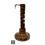 An 18th Century rat de cave candlestick, on turned wooden base, height 19cm.
