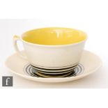 A 1930s Art Deco Susie Cooper yellow Tango pattern breakfast cup and saucer, saucer diameter 19cm.