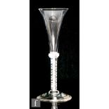 An 18th Century drinking glass circa 1760, the drawn trumpet bowl above three basal collars and a