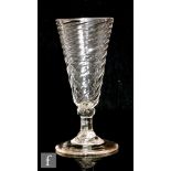 An 18th Century ale drinking glass circa 1740, the wrythen fluted bowl above a knopped stem,