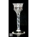 An 18th Century drinking glass circa 1770, the waisted ogee bowl with engraved floral border above a