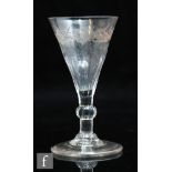 An 18th Century wine glass circa 1780, the drawn funnel bowl engraved with a floral spray above