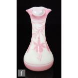 A late 19th Century Stourbridge cameo glass vase of slender drawn form with a triform rim, cased