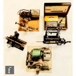 Two watch maker lathes each mounted on plinth bases with electric motors, a similar hand crank