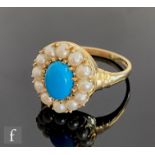 A 9ct hallmarked turquoise and seed pearl cluster ring, central oval turquoise within a twelve stone