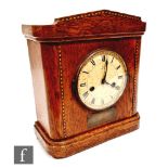 An early 20th Century oak cased mantel clock with chequer strung inlay and German movement