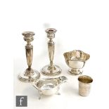 A small parcel lot of assorted silver items to include a small pedestal bowl, a sauce boat, a pair