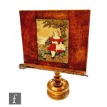 A Victorian figured walnut adjustable book or music stand inset with an embroidered panel, on a