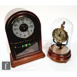 A early 20th Century French Bulle patent mantle clock, the movement enclosed by an arched glazed