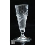 An 18th Century ale glass circa 1700, the moulded funnel bowl with wrythen flammiform decoration