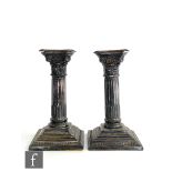 A pair of hallmarked silver Corinthian column piano candlesticks of typical form, height 16cm,