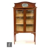 An Edwardian mahogany and satinwood cross-banded display cabinet, with a shallow upright section