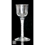 An 18th Century drinking glass circa 1765, the ogee bowl above a single/double series opaque twist