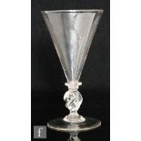 A late 17th to early 18th Century continental Facon de Venise wine glass, the conical bowl on a