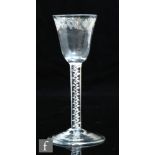 An 18th Century wine glass circa 1760, the round funnel bowl engraved with a border of cartouche and