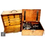 A 1930s oak cased engineers tool chest by M &W fitted with an arrangement of nine drawers with