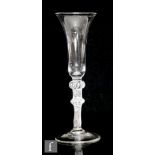 An 18th Century drinking glass circa 1755, the tall slender bell bowl above a double knopped multi