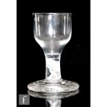An 18th Century glass circa 1765, the ogee bowl above a shallow double series opaque twist stem with
