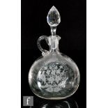 A late 19th Century Stourbridge clear crystal claret jug of compressed ovoid form with loop handle