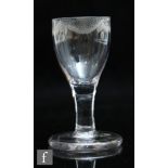 An 18th Century dram glass circa 1750, the ovoid bowl with an engraved garland to the rim, above a