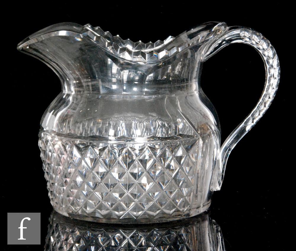 A late Georgian Anglo-Irish water jug of ovoid form with a strawberry diamond band beneath a slice