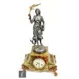 An early 20th Century French mantle clock mounted with a figure holding a book and a gilt sprig on