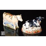 Two boxed Royal Crown Derby paperweights comprising Lily and Friesian Cow 'Buttercup', both with