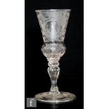 An 18th Century Silesian drinking glass circa 1750, the thistle form bowl engraved with an ornate