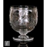 An early 20th Century glass vase of chalice form, intaglio cut and polished with flowers within