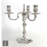 A hallmarked silver three light candelabra, hexagonal stepped base below a knopped stem and three