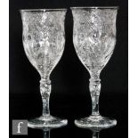 A pair of large early 20th Century Stevens & Williams wine glasses with a swollen ovoid and lipped