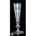 An 18th Century drinking glass circa 1710, possibly Bohemian, the tall funnel bowl engraved with