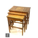 A nest of three Arts and Crafts oak occasional tables of rectangular form, the largest table with