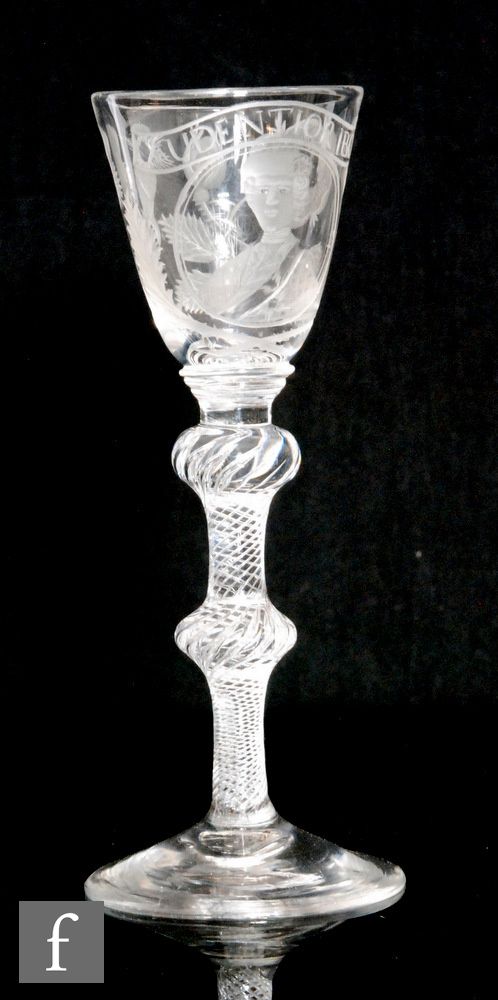 An 18th Century drinking glass circa 1750, the round funnel bowl engraved with a head and