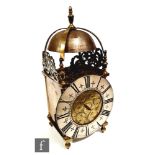 A 17th Century style brass lantern clock the silvered chapter ring inscribed Davis London, lacking