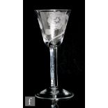 An 18th Century Jacobite drinking glass circa 1750, the round funnel bowl engraved with seven