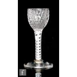 An 18th Century drinking glass circa 1765, the honeycomb moulded ogee bowl above a double series