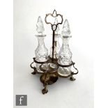 A Victorian hallmarked silver and clear glass cruet set, the silver four section stand raised on