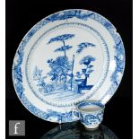 A Chinese 18th Century blue and white charger of circular form with a shallow well, the central