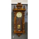 A 19th century Vienna walnut cased regulator wall clock the spring driven moment enclosed by a