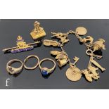 A small parcel lot of assorted 9ct items to include a charm bracelet with two silver gilt coins, a