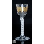 An 18th Century drinking glass circa 1765, the ogee form bowl gilded in the manner of James Giles