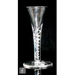 An 18th Century drinking glass circa 1750, the drawn trumpet bowl above a single series air twist