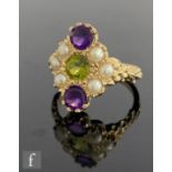 A 9ct hallmarked amethyst, peridot and seed pearl set ring, central peridot with an amethyst set